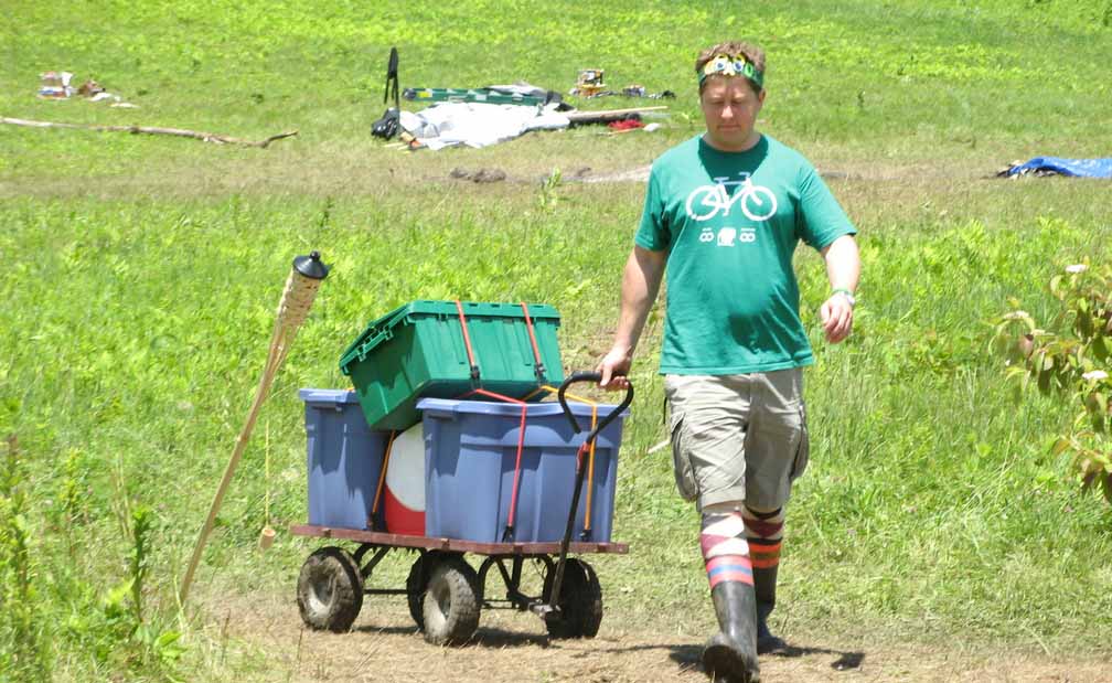 A Firefly pulls a cart loaded with storage bins.