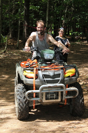 Two Fireflies ride an ATV.