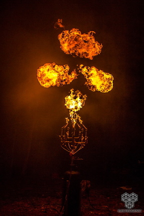 A metal sculpture shoots balls of flame.