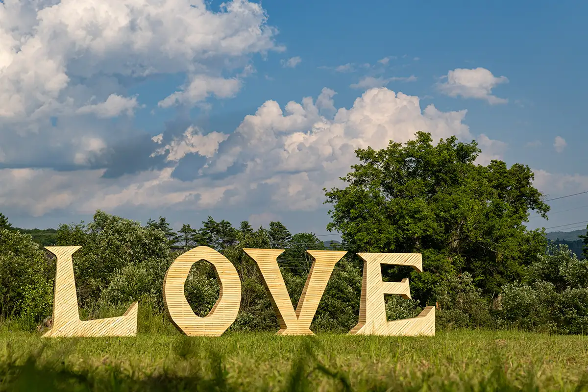 Large wooden letters on the Firefly field spell the word "LOVE".